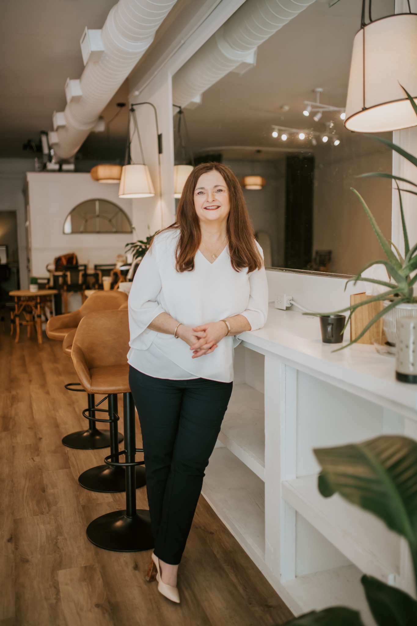Angela Conner Foland standing in a warm, welcoming interior